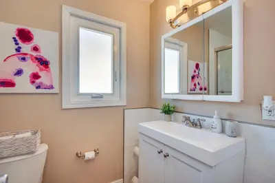 a bathroom with a white sink and a mirror at LA Condo about 1 Mi to The Kia Forum and SoFi Stadium in Inglewood