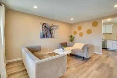 a living room with two couches and a table at LA Condo about 1 Mi to The Kia Forum and SoFi Stadium in Inglewood