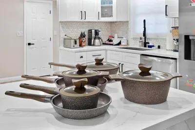 a kitchen with four pots on a counter at Gamers Getaway by OC Adventure Homes in Stanton