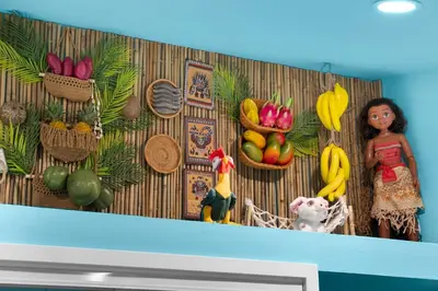 a wall with toy dolls and fruit on it at Underwater Voyage by OC Adventure Homes in Garden Grove