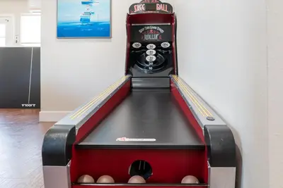 a bowling alley with balls in the middle at Underwater Voyage by OC Adventure Homes in Garden Grove