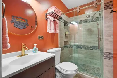 a bathroom with a shower and a toilet and a sink at The Disneyland Dream by OC Adventure Homes in Garden Grove