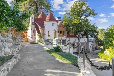 a large white house with a stone wall at The Magic Castle (Unit5) - Six Flags in Newhall