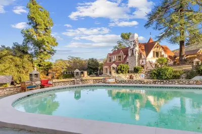 a large swimming pool in front of a house at The Magic Castle (Unit5) - Six Flags in Newhall