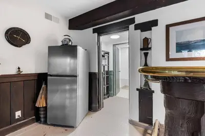a kitchen with a refrigerator and a clock on the wall at The Magic Castle (Unit5) - Six Flags in Newhall