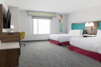 a hotel room with two beds and a flat screen tv at Hampton Inn & Suites Porter Ranch Los Angeles in Deer Lake Highlands