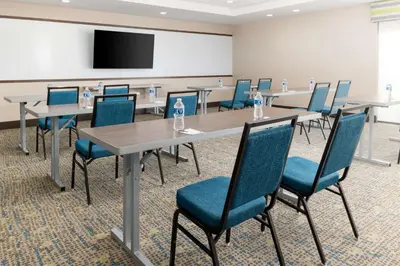 a conference room with tables and chairs and a screen at Hampton Inn & Suites Porter Ranch Los Angeles in Deer Lake Highlands