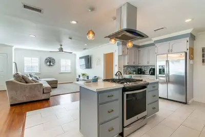 a kitchen with a stove top oven in a room at Coastal Retreat With a minimum stay of 30 days in Lakewood