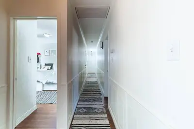 a hallway with white walls and a hallway with a mirror at Coastal Retreat With a minimum stay of 30 days in Lakewood