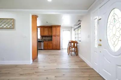 a hallway with a white door and a wooden floor at Beautiful Spacious Home in Los Angeles