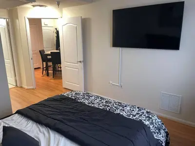 a bedroom with a bed and a flat screen tv at Luxury 2 bedroom apartment in downtown LA! in Los Angeles