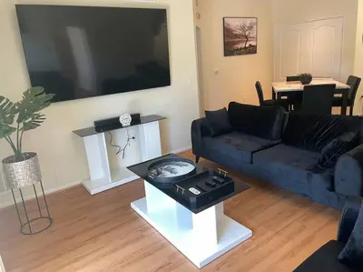 a living room with a couch and a large television at Luxury 2 bedroom apartment in downtown LA! in Los Angeles