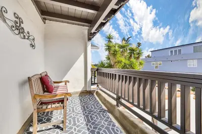 a porch with a chair on a balcony at Historic Spanish Home at Hollywood Beach in Oxnard