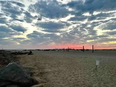 a sunset on a beach with a cloudy sky at Historic Spanish Home at Hollywood Beach in Oxnard