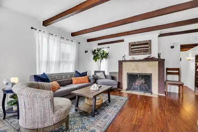 a living room with a couch and a fireplace at Historic Spanish Home at Hollywood Beach in Oxnard