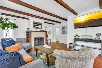 a living room with two chairs and a fireplace at Historic Spanish Home at Hollywood Beach in Oxnard