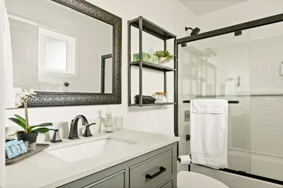a white bathroom with a sink and a mirror at EV level 2, Pets Welcome at Sunset Ridge in Lake Arrowhead