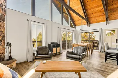 a living room with a table and chairs at EV level 2, Pets Welcome at Sunset Ridge in Lake Arrowhead
