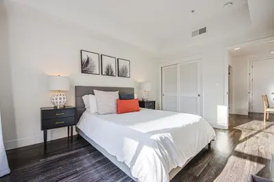a white bedroom with a large bed and two lamps at Outstanding 2BDR in SM- 5-15 mins to the beach! in Los Angeles