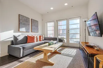 a living room with a couch and a coffee table at Outstanding 2BDR in SM- 5-15 mins to the beach! in Los Angeles