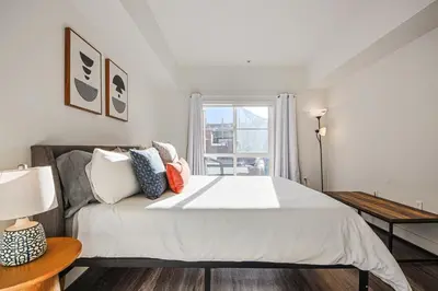 a bedroom with a large bed and a window at Outstanding 2BDR in SM- 5-15 mins to the beach! in Los Angeles