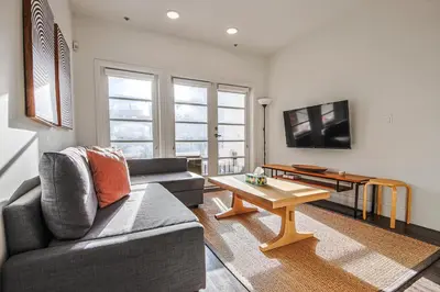 a living room with a couch and a coffee table at Outstanding 2BDR in SM- 5-15 mins to the beach! in Los Angeles