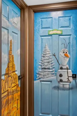 a door with a snowman and a christmas tree on it at Great Outdoors by OC Adventure Homes in Garden Grove