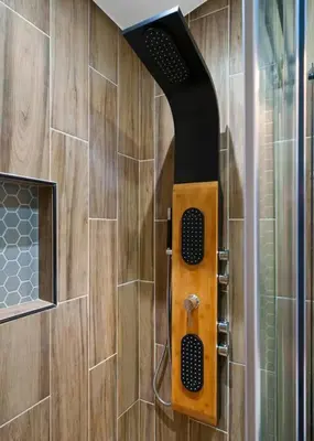a shower in a bathroom with a wooden wall at Great Outdoors by OC Adventure Homes in Garden Grove