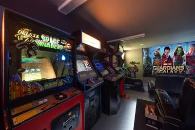 a gaming room with two video game machines at Avengers Campus by OC Adventure Homes in Buena Park