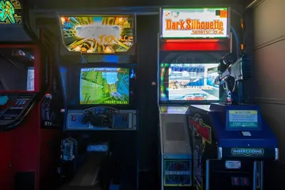 a video game arcade with two video game machines at Avengers Campus by OC Adventure Homes in Buena Park