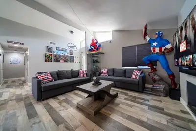 a living room with a superhero statue on the wall at Avengers Campus by OC Adventure Homes in Buena Park