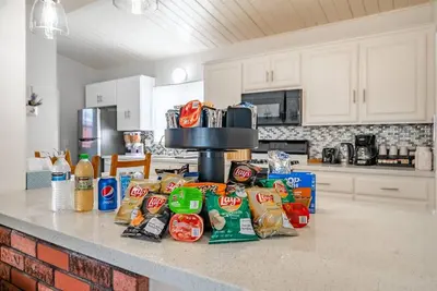 a kitchen counter with a bunch of food on it at Dino Disneyland by OC Adventure Homes in Garden Grove