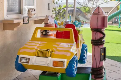 a childs toy toy car on a playground at Dino Disneyland by OC Adventure Homes in Garden Grove