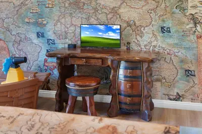 a wooden table with a computer on top of a wall at Pirate Cove by OC Adventure Homes in Garden Grove