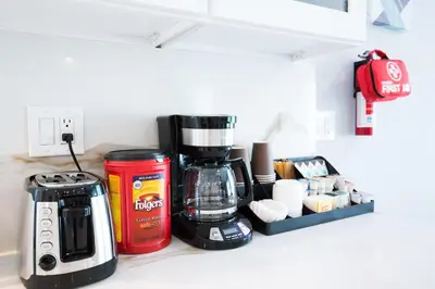 a kitchen counter with a coffee maker and a coffeemaker at Safari Adventure by OC Adventure Homes in Garden Grove