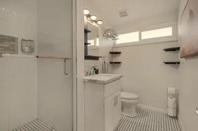 a white bathroom with a sink and a toilet at Safari Adventure by OC Adventure Homes in Garden Grove
