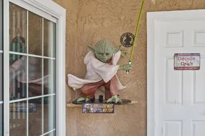 a statue of the grinch on a wall next to a door at Galactic Dream by OC Adventure Homes in Garden Grove