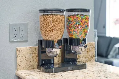 two large containers filled with cereal and candy at Galactic Dream by OC Adventure Homes in Garden Grove