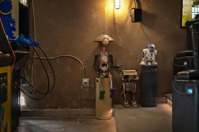 a room with two robots sitting next to a wall at Galactic Dream by OC Adventure Homes in Garden Grove