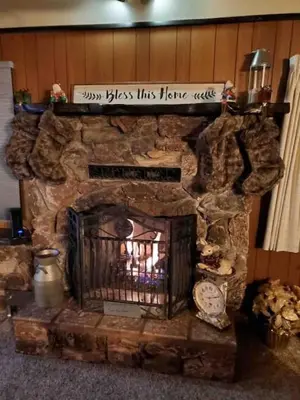 a stone fireplace with a sign on top of it at Green Pines Lake Retreat Walk to Lake in Big Bear Lake