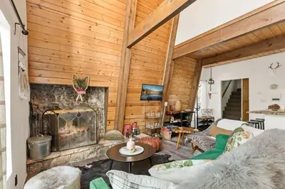 a living room with a fireplace in a house at Lucky Bear Cabin in Big Bear Lake