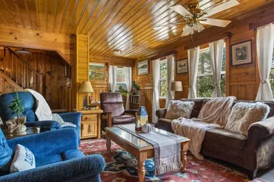 a living room with blue furniture and a wooden ceiling at Boulder Bay Getaway in Big Bear Lake