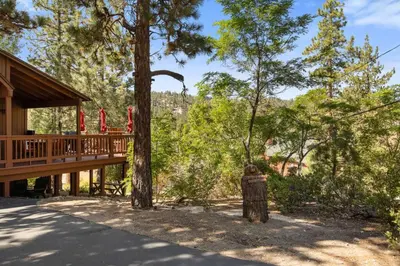 a house with a fire hydrant next to a tree at Boulder Bay Getaway in Big Bear Lake