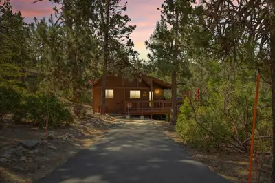a cabin in the woods with a driveway at Boulder Bay Getaway in Big Bear Lake