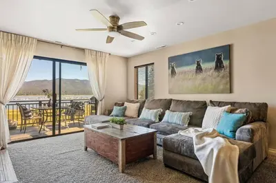a living room with a couch and a ceiling fan at Lakefront at the Village in Big Bear Lake
