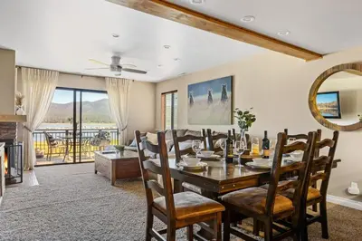 a dining room with a table and chairs and a fireplace at Lakefront at the Village in Big Bear Lake