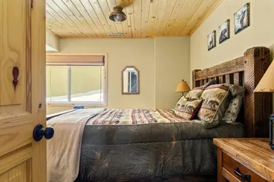 a bedroom with a bed and a window at Slope Vista Escape in Fawnskin