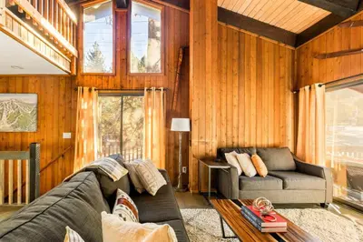 a living room with a couch and a table at NEW Summit Lookout in Big Bear Lake