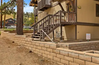 a brick retaining wall with a staircase in front of a building at NEW Summit Lookout in Big Bear Lake