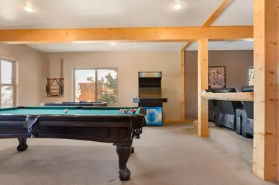 a room with a pool table and a bunk bed at Sky High Mountain Lodge Lake View in Big Bear Lake